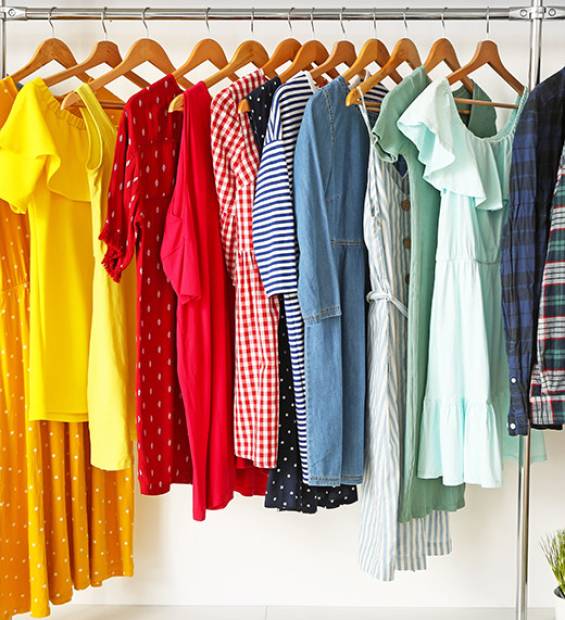Stylish clothes on hangers in show room Stylish clothes on hangers in show room